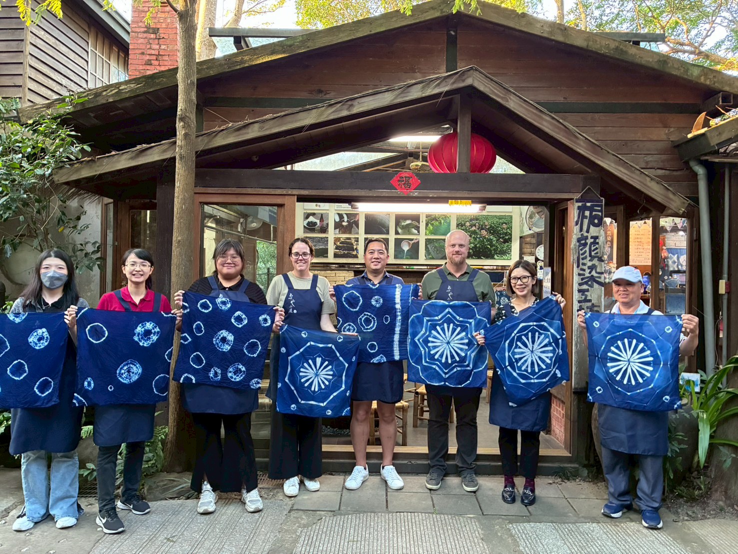 Image 2. Holland America Travel Product Manager Madeleine Ninness (4th from left), Seabourn Manager for Deployment Planning & Analysis Jeff Shieh (5th from left), Holland America Deployment & Itinerary Planning Manager Chris Bacon (3rd from right), and other delegates visit an indigo dyeing experience workshop
